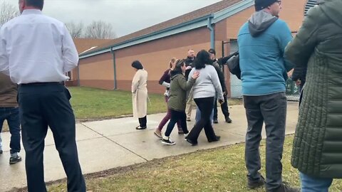 Concerned parents wait for students after fake threat put a high school into lockdown