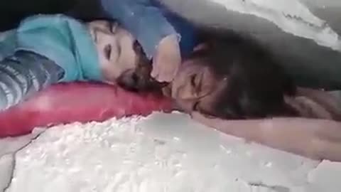 She protected her brother's head under the rubble