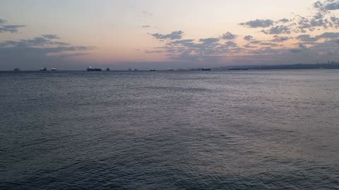 A beautiful view of the calm sea and the beauty of the clouds and distant ships