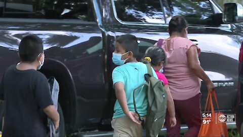 Migrant worker parents thankful for backpack give away ahead of first day of school