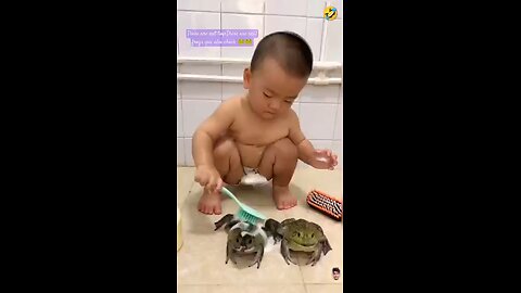 cute baby playing with frogs