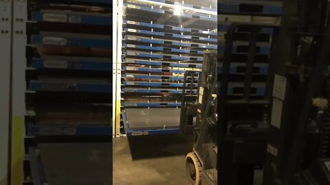 Forklift Operator using Lean Sheet Metal Storage Racks and Re-Rack Cartridges