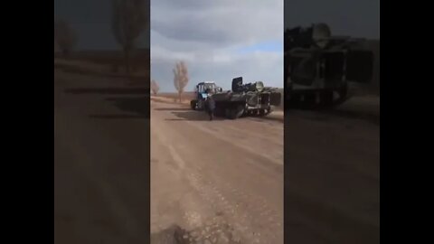 Ukrainian farmer tows away Russian armored vehicle