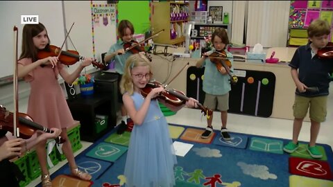 Sean Daly gets a live look at MacFarlane Park Elementary violin class