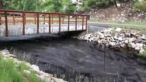 North Fork Big Thompson River raging with mud and debris from the burn scar