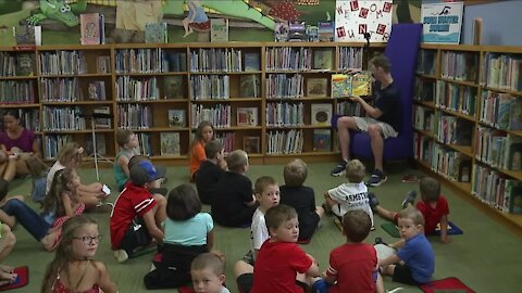 Dover native, Olympic gold medal swimmer Hunter Armstrong reads to children at local library