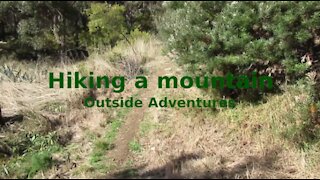 Hiking a mountain: Outside Adventures