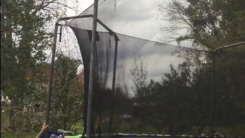 Kid Does Skateboard Tricks On Trampoline But Falls Climbing Out of the Netting