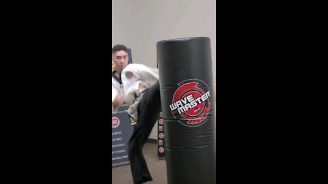 3rd Degree Black Belt Kicking The Bag At Taekwondo Class (Volume Up)