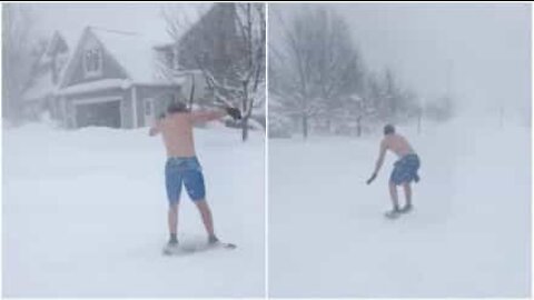 Kid surfs the snow in board shorts