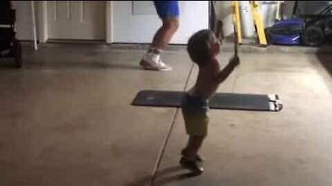 Toddler joins dad in jump rope workout