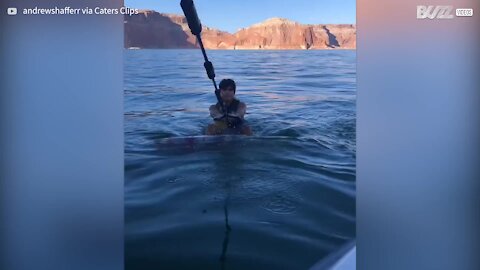 Graduate rides wakeboard in stylish end of course photo op!