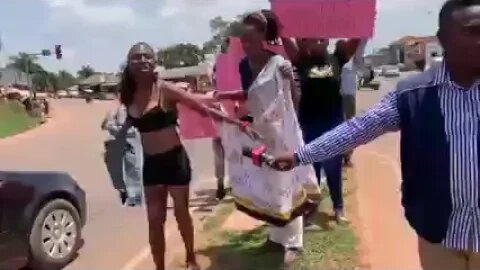 A woman in Entebbe undressed in the middle of the road.