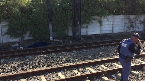 SOUTH AFRICA - Cape Town - The corpse of a young male lay alongside the train track in Southfield. (Video) (G7W)