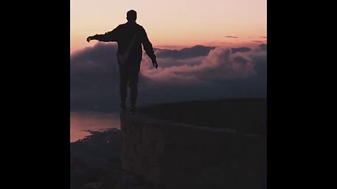 Man sneaking on the top of a wall with beautiful sky code