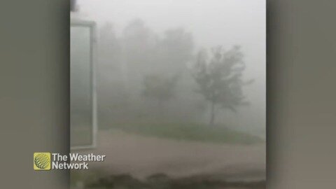 Rain barrel overflows as heavy rain and wind lashes home