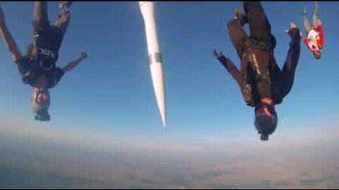 Skydivers jump with a missile