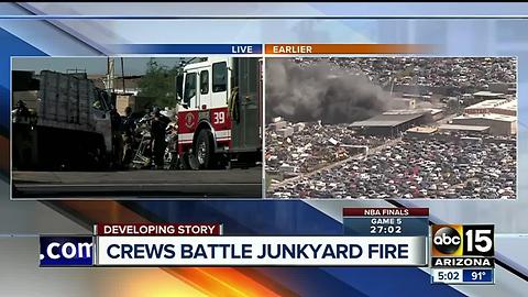 Fire crews battle first-alarm fire at a junkyard in Phoenix