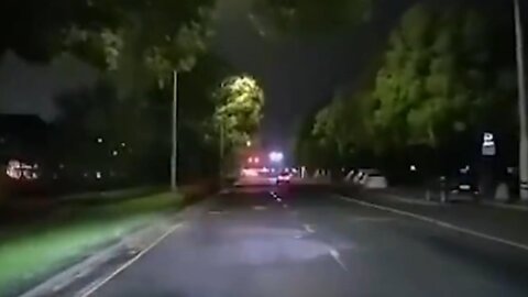 Lightening striking a tree in front of a car