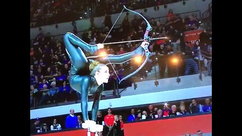 basketball halftime show where an acrobat shoots an arrow with her feet