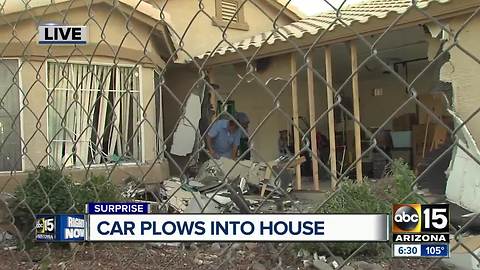 Car plows into Surprise home injuring driver