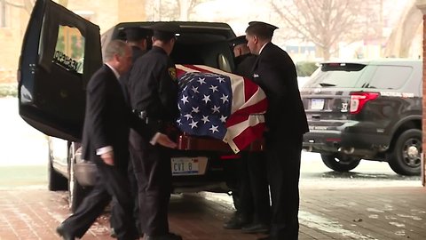 John Dingell's casket put into hearse