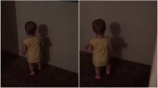 Cute baby puzzled by her own shadow