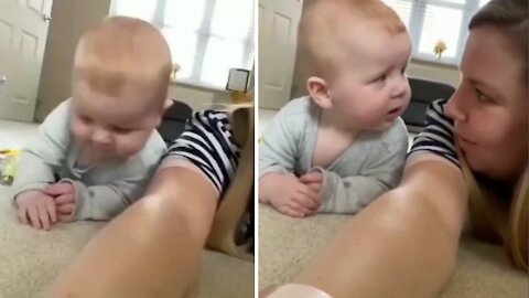 Baby making his funny face when accidentally collide with mom when playing