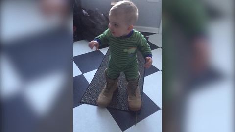 "Cute Toddler Boy Tries on Dad’s Army Boots"