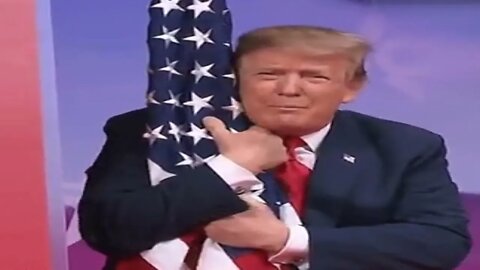 Trump hugs and kisses the American flag