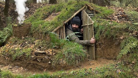 Building complete and warm survival shelter _ Bushcraft earth hut, grass roof & fireplace with clay