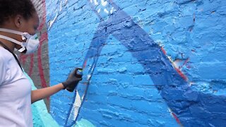 Lansing children create mural on the side of the Granger Building