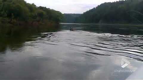 Fisherman captures an elk crossing river