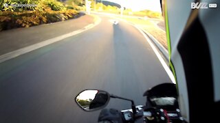 Motorcyclist narrowly avoids disaster with car driven in opposite direction!