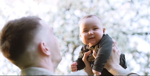 Adorable baby laughing with father