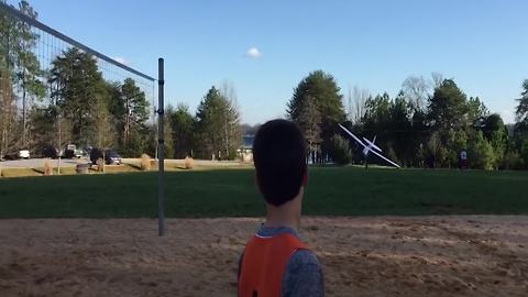 Father And Son Having Fun Flying A Remote-Control Airplane