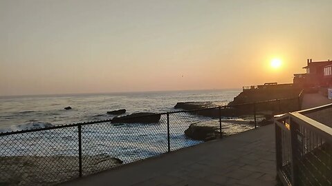 The sun hangs low over The Monterey Bay