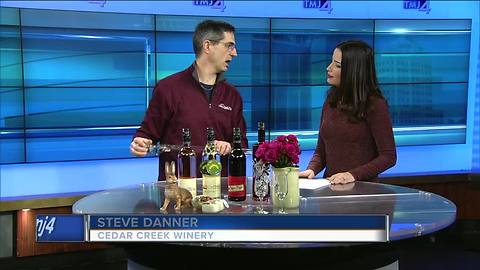 Taste wine out of a barrel at 28th anniversary for Cedar Creek Winery