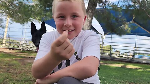 Grayson eating a pear from a cactus