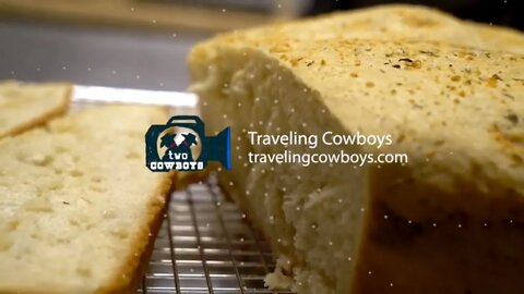 Two Cowboys Are Baking Yoder Bread in a Cast Iron Pot on a Pellet Cooker in Greenwood, BC