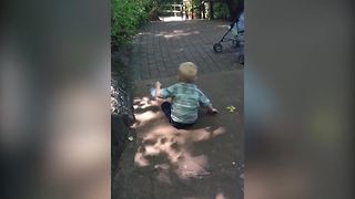 Little Boy Thinks That A Hill Is A Slide