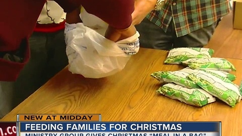 Families in need receive Christmas Meal-In-A-Bag for their holiday dinners this weekend