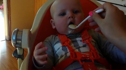 Baby having fun while eating, mom not so much!