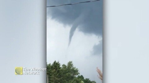 Thin funnel cloud reaching down on active day in Ontario