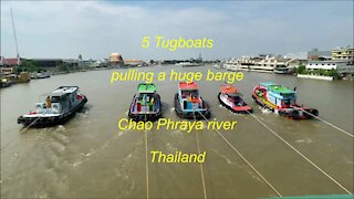 5 Tugboats pulling a barge at Chao Phraya river in Bangkok Thailand