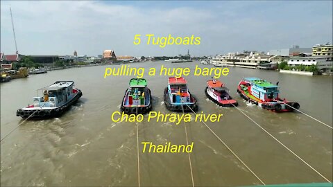 5 Tugboats pulling a barge at Chao Phraya river in Bangkok Thailand