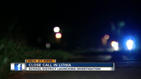 Driver says two girls nearly hit by car blowing past stopped school bus in Lithia