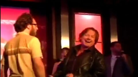 Rowdy Roddy Piper and Ari Shaffir on stage.