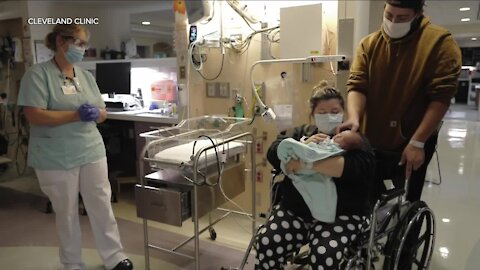 Newborn baby helps father with adorable surprise proposal at Cleveland Clinic