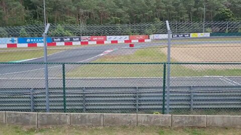 E racers overtaking at Circuit Zolder. Electric car racing